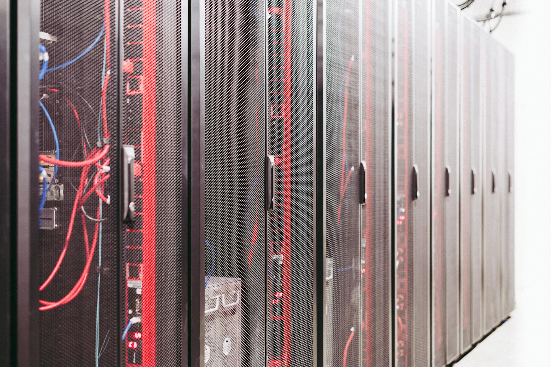 Modern data server room with network racks and cables.