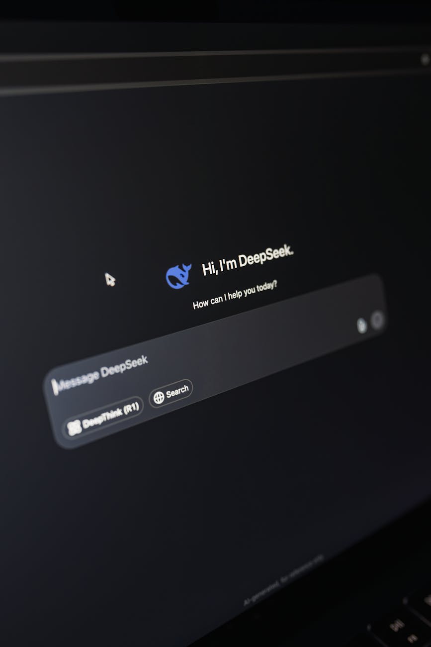 Close-up of a laptop displaying an AI interface with a chatbot prompt in dark mode.