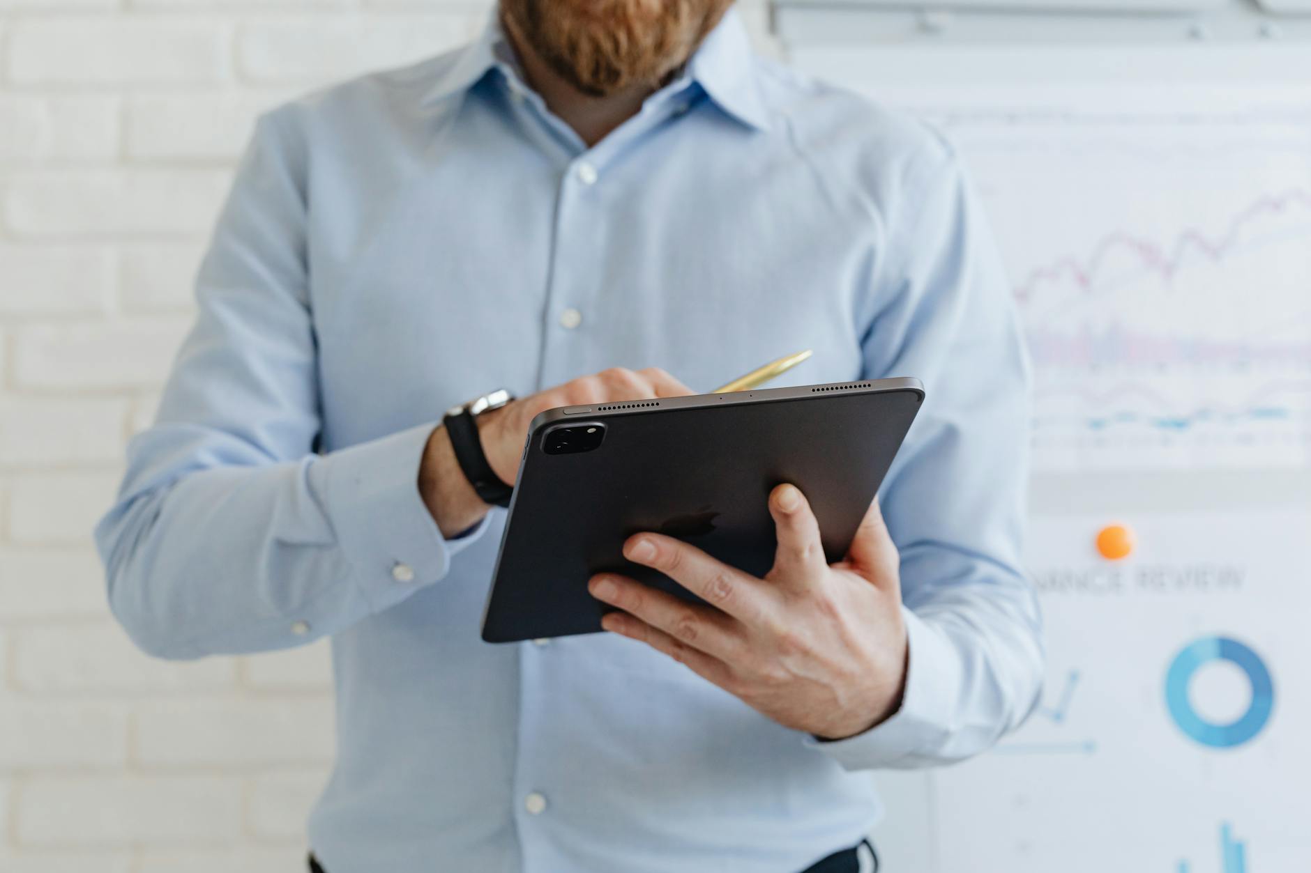 Businessman using a tablet for data analysis in a modern office.