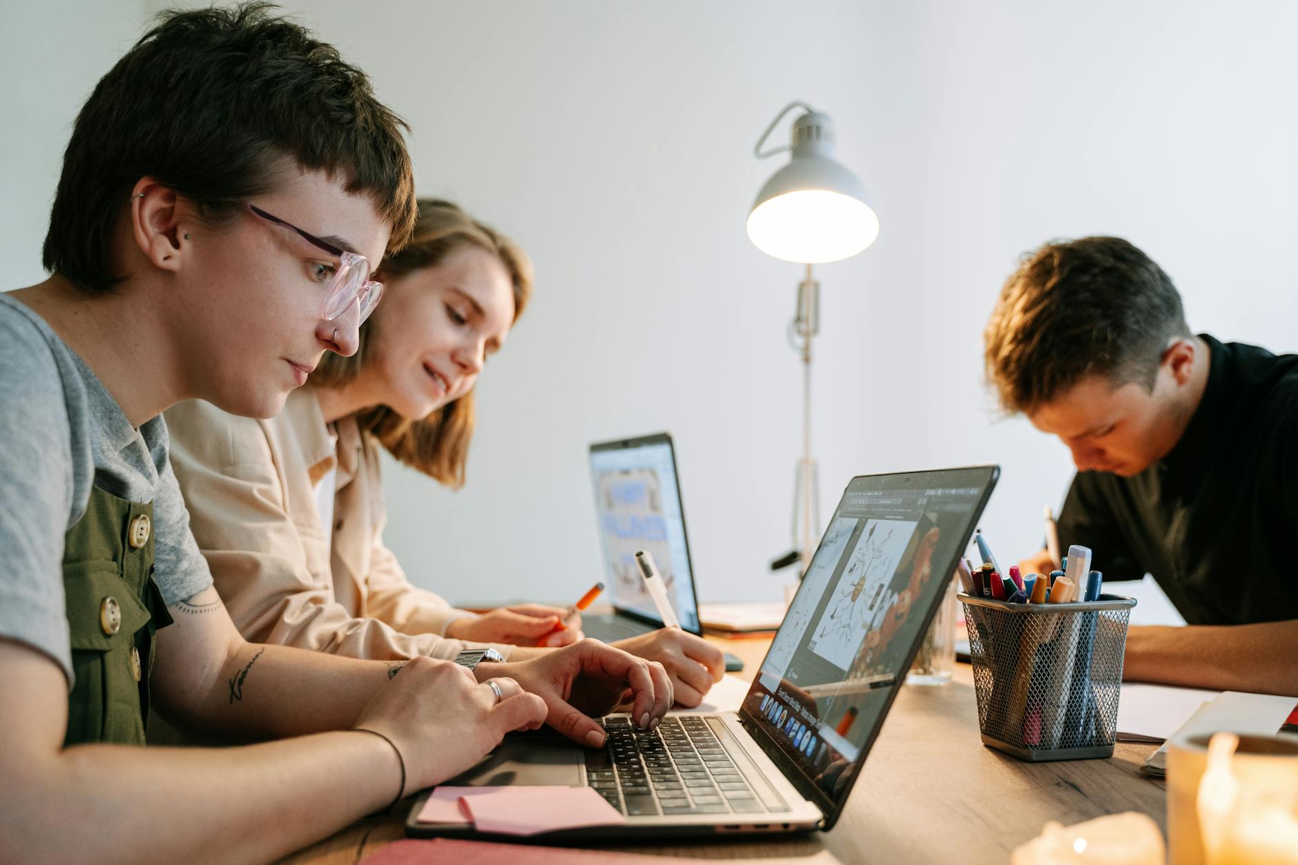 Young creative professionals collaborating on a project in a modern workspace. Perfect teamwork depiction.