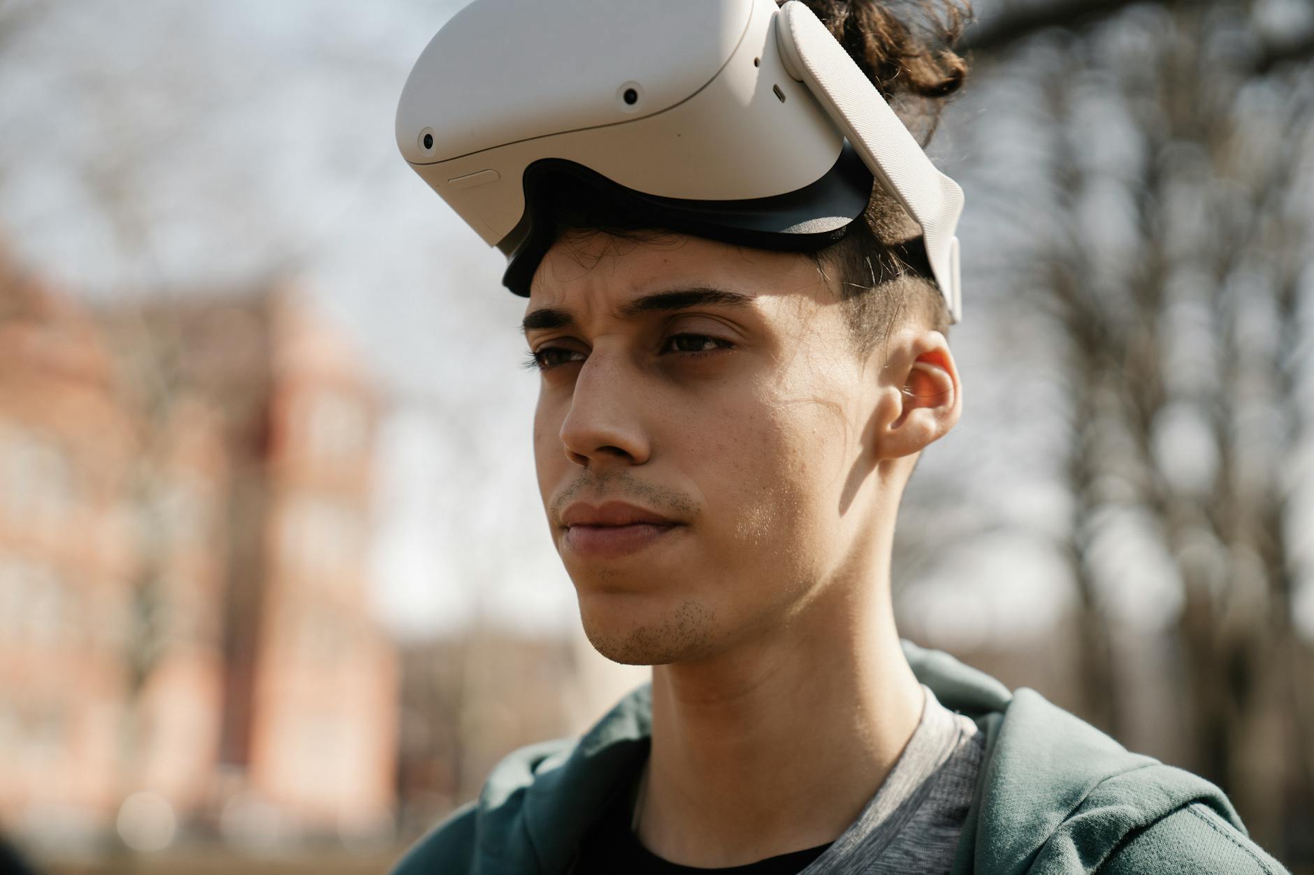 A young man outdoors wearing a VR headset, capturing the modern technology lifestyle.