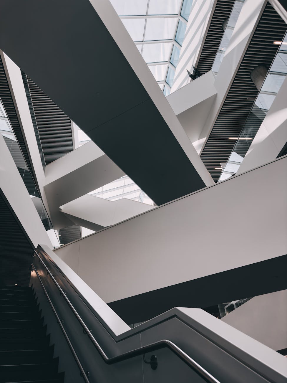 Futuristic interior view of a modern architectural staircase with geometric design elements.