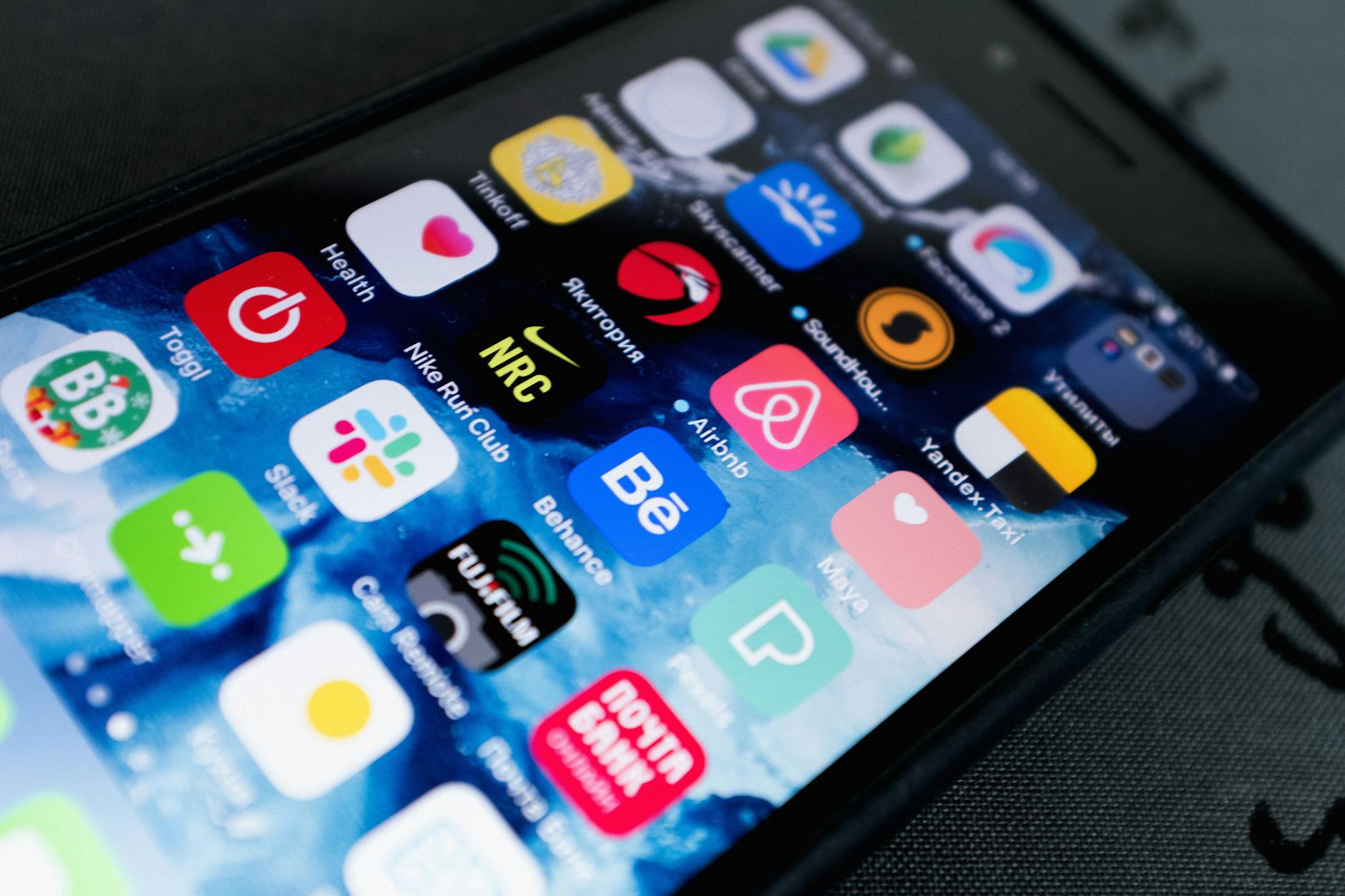 Detailed view of smartphone displaying multiple app icons on screen, highlighting technology use.