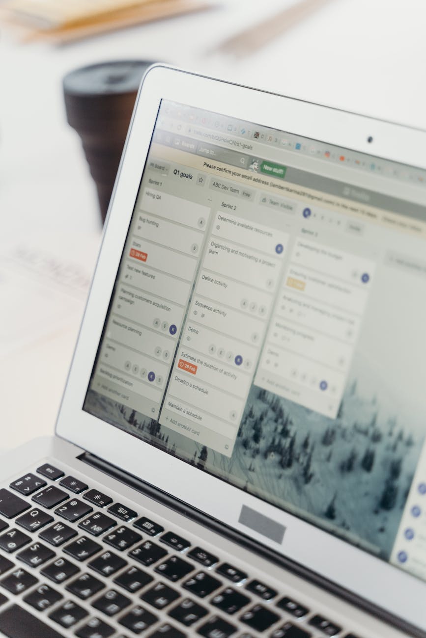 Close-up of a laptop screen showing project management software interface. Perfect for business or tech themes.