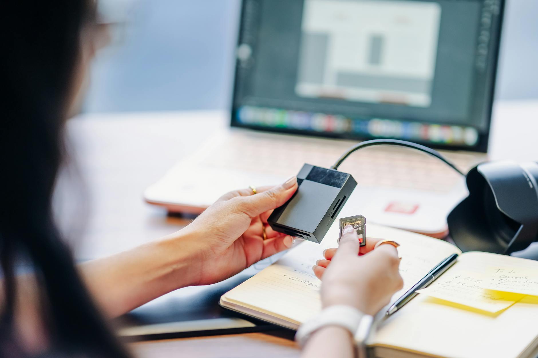 Close-up of a person using a card reader with a laptop, ideal for tech or remote work themes.